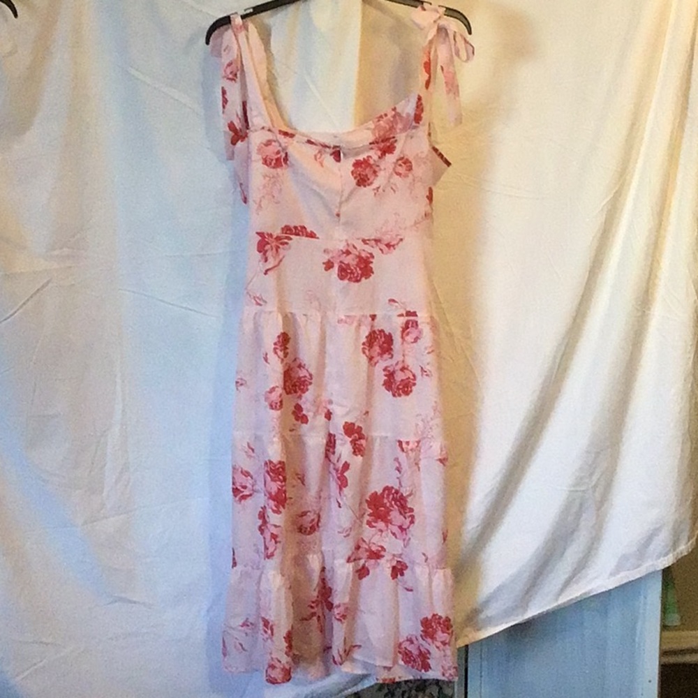 NWOT, pink floral dress with adjustable, self tie straps. Unlined